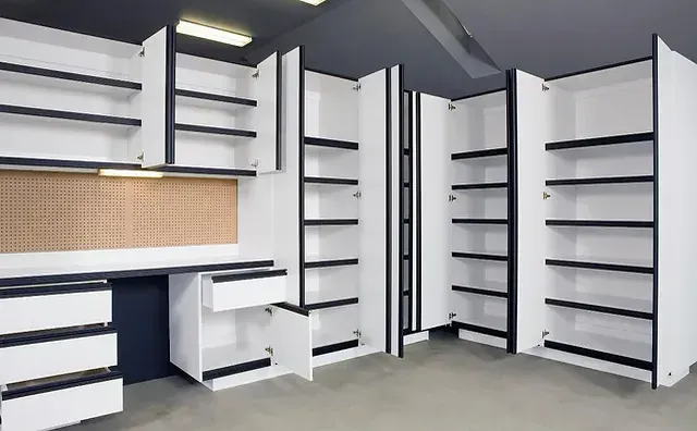 Adjustable shelves inside a garage cabinet, set at different heights.