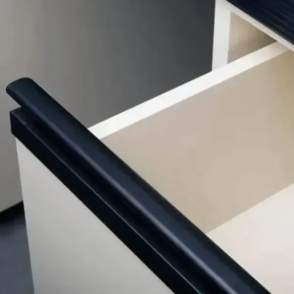 Close-up of an aluminum finger pull handle running along a cabinet door edge.